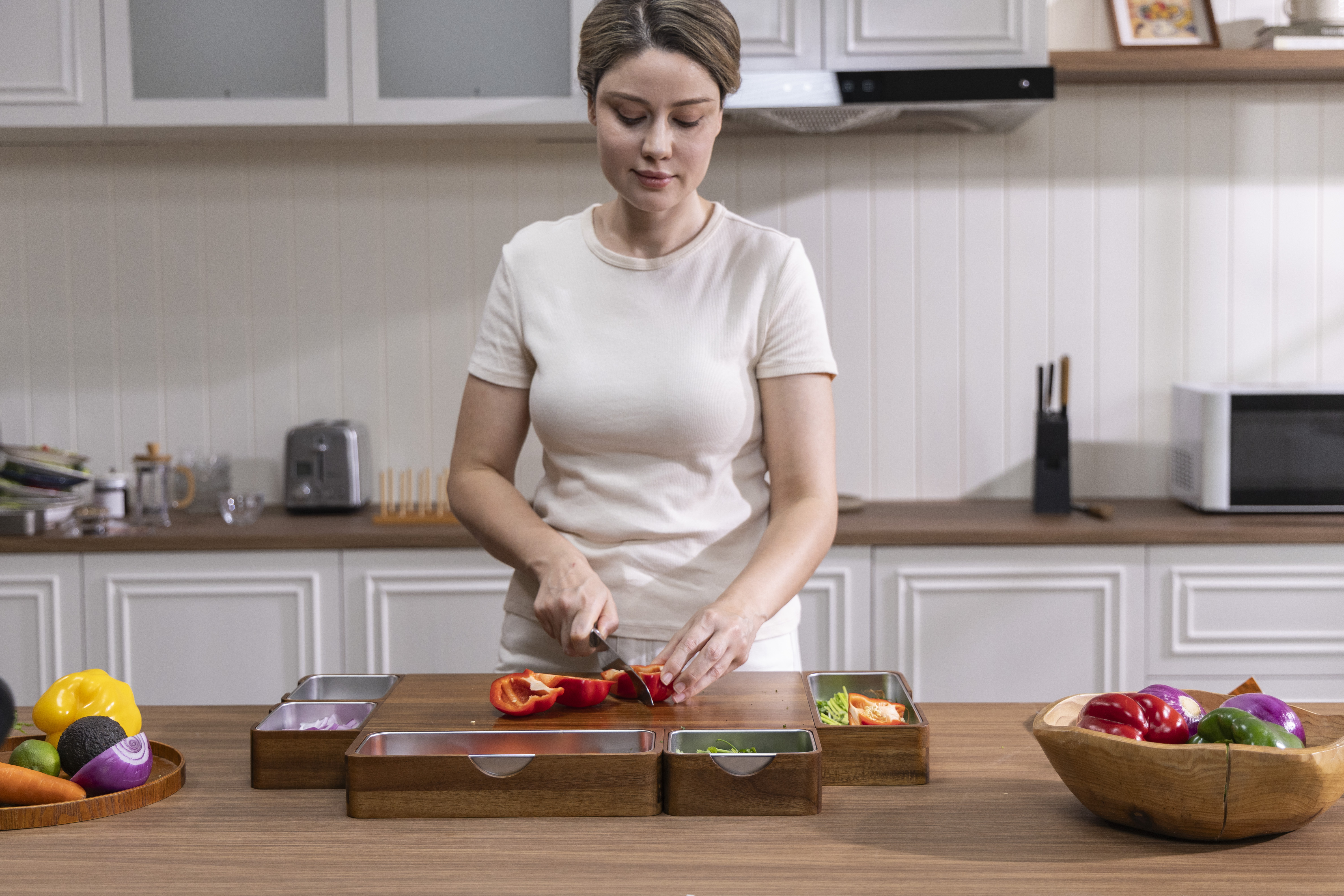 Woman slicing red bell pepper on the MESTOV PrepTop modular meal prep workstation